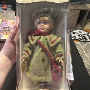 Vintage Doll with Green Coat and Red Accents